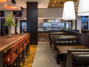 a restaurant with wooden tables and leather chairs at Parkwest Bicycle Casino in Bell Gardens