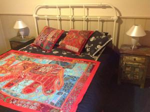 a bed with colorful blankets and pillows on it at Pemberton in Beechworth