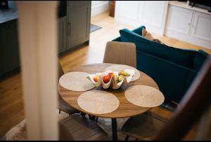 a table with a bowl of fruit on it in a living room at Mount Auldyn House - The Cottage in Ramsey +6 photos