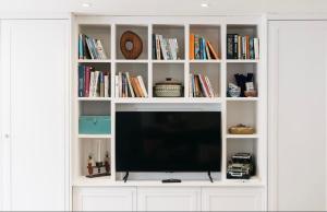 a white book shelf with a television in it at Mount Auldyn House - The Cottage in Ramsey