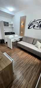a living room with a couch and a table at Flat S4 Hotel - Águas Claras - Brasília in Brasilia