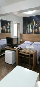 a bedroom with two beds and a desk with a computer at Flat S4 Hotel - Águas Claras - Brasília in Brasilia +24 photos