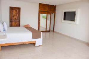 Voodi või voodid majutusasutuse Hotel en Tequesquitengo toas