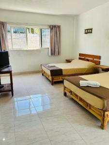 Voodi või voodid majutusasutuse Hotel en Tequesquitengo toas