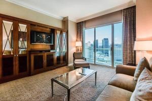 a living room with a couch and a tv at MGM 1BR Mountain View Balcony 28802 in Las Vegas