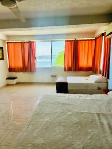 Voodi või voodid majutusasutuse Hotel en Tequesquitengo toas