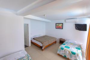 Ένα ή περισσότερα κρεβάτια σε δωμάτιο στο Hoteles Perú Hosting - Punta Sal +18 φωτογραφίες