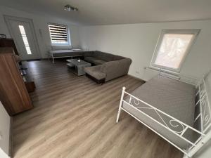 a living room with a couch and a bed at Grosse Möblierte Wohnung Zu Vermieten an der BAB 15 in Kolkwitz +2 photos