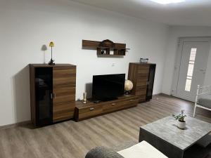 a living room with a flat screen tv on a entertainment center at Grosse Möblierte Wohnung Zu Vermieten an der BAB 15 in Kolkwitz
