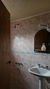 ein Badezimmer mit Waschbecken und Spiegel in der Unterkunft Casa Chalet Lamar alojamiento entero in Santa Clara del Mar