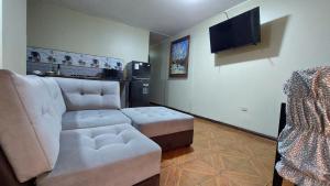 a living room with a couch and a tv at Carosvi Home in Lima