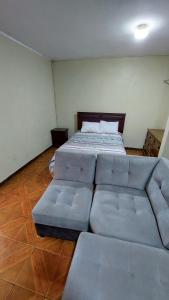 a bedroom with a bed and a couch in it at Carosvi Home in Lima