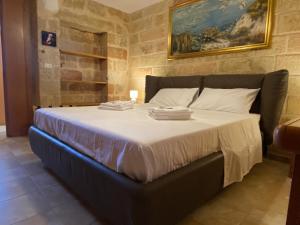 a bedroom with a large bed with towels on it at L'Alba dei Sogni in Marina Serra +86 photos