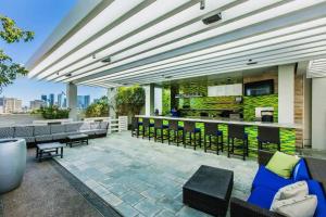 a rooftop patio with chairs and a bar at Mountain-View Studio w BALCONY ACCESS Palms 36305 in Las Vegas
