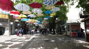 a group of umbrellas hanging over a street at Hotel MERIDA in Blagoevgrad