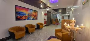 a waiting room with chairs and a painting on the wall at BlueNeck Ayodhya-Near ShriRam Mandir in Ayodhya