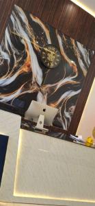 a clock on top of a counter with a laptop at BlueNeck Ayodhya-Near ShriRam Mandir in Ayodhya