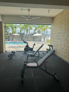 a group of exercise bikes in a gym with a pool at Alojamiento en Boca Chica in Boca Chica