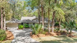 a house with trees and a driveway at Vicino al Mare in Hilton Head Island