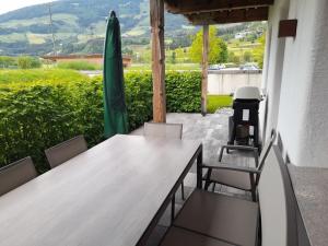 a table and chairs on a patio with a view at Alpin Residenzen Top 12 in Hollersbach im Pinzgau