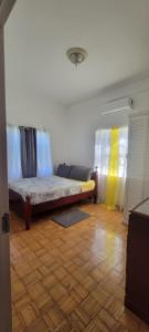 a living room with a couch and a bed at Dominic Apt at Mt Hartman in Golflands