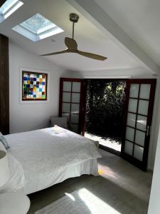 a bedroom with a bed and a ceiling fan at Oma’s Kitchen at Creegans Cottage in Barkers Vale
