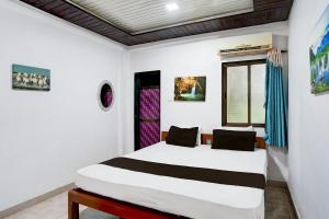 Postel nebo postele na pokoji v ubytování Hotel O Raj Resort