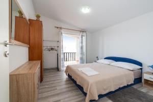 a bedroom with a bed and a dresser in it at Apartments with a parking space Nin, Zadar - 23493 in Nin