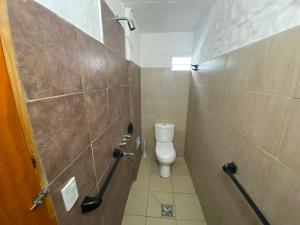 a small bathroom with a toilet in a stall at la cinco (5) in Villa Gesell