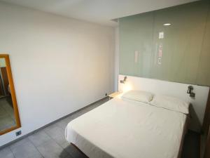 a bedroom with a white bed and a mirror at Olof Apartment in Las Palmas de Gran Canaria +29 photos