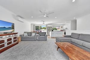 a living room with a couch and a table at Gidget's Getaway in Nelson Bay