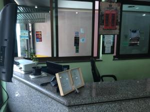 an office with a counter with a computer on it at Saville Hotel in Sao Paulo
