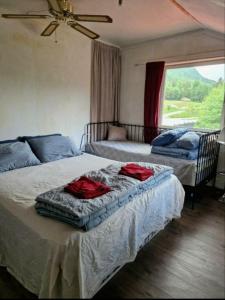 a bedroom with two beds with red shirts on them at Holiday Home Villa Gol in Gol