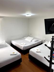 Postel nebo postele na pokoji v ubytování Hotel Quintas de Bogotá