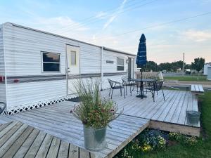 a trailer with a table and chairs on a deck at Pelican Motel in Pelican Rapids