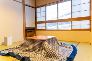 Postel nebo postele na pokoji v ubytování Hotel GOOD DAY Yuzawa