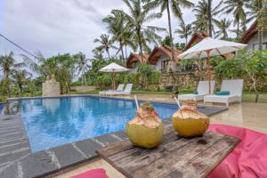 a villa with a swimming pool and a resort at Mahendra Cottage in Nusa Penida +56 photos