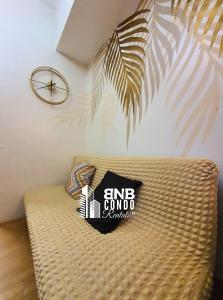 a pillow on a couch with a sign on it at Studio2 - BNB Condo Rentals CDO in Lapasan