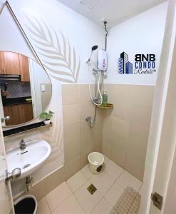 a bathroom with a sink and a toilet at Studio2 - BNB Condo Rentals CDO in Lapasan