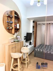 a small room with two stools and a bedroom at Studio2 - BNB Condo Rentals CDO in Lapasan