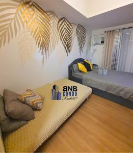 a bedroom with two beds and a mattress on the floor at Studio2 - BNB Condo Rentals CDO in Lapasan