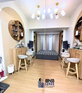 a salon with stools and a mirror in a room at Studio2 - BNB Condo Rentals CDO in Lapasan