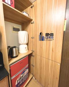 a kitchen with a door with a sign on it at Studio2 - BNB Condo Rentals CDO in Lapasan +8 photos