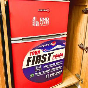 a red fire extinguisher sitting in a shelf at Studio2 - BNB Condo Rentals CDO in Lapasan