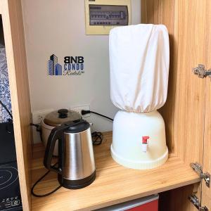 a white blender sitting on top of a counter at Studio2 - BNB Condo Rentals CDO in Lapasan