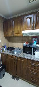 a kitchen with a sink and a microwave at Furnished daily studio basis in Dubai
