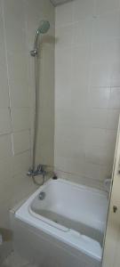 a white bath tub in a bathroom with a shower at Furnished daily studio basis in Dubai