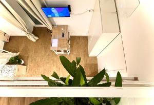 an overhead view of a living room with plants at Apuliantales Bari-Cozy Suite in Carbonara di Bari