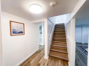 een trap in een huis met witte muren en houten vloeren bij Charming 2BR 2BA in Great Falls! in Great Falls +10 foto's
