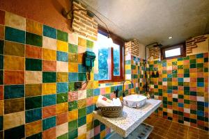 a bathroom with colorful tiled walls and a sink at La Rocca An Bang Beach in An Bàn (2) +41 photos